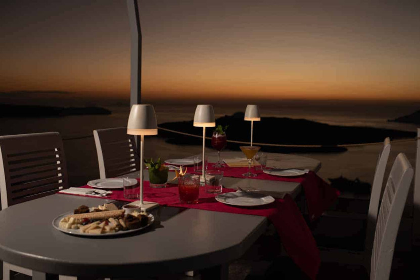 Cozy dinner with a view onto the Caldera in Santorini, Greece.