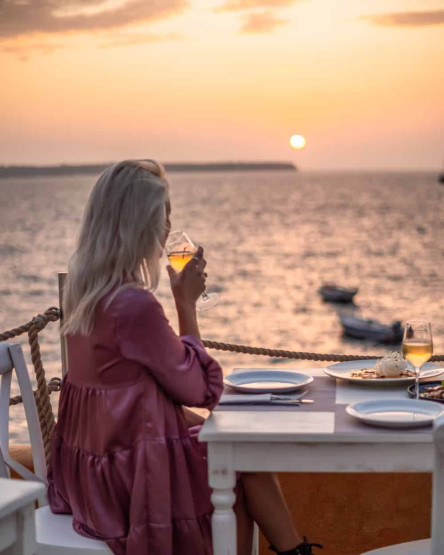 Romantic Sunset Restaurants in Santorini - How to Reserve the Best Romantic Sunset Restaurants in Santorini, Greece Sunset at the Sunset Ammoudi restaurant in Santorini, Greece.