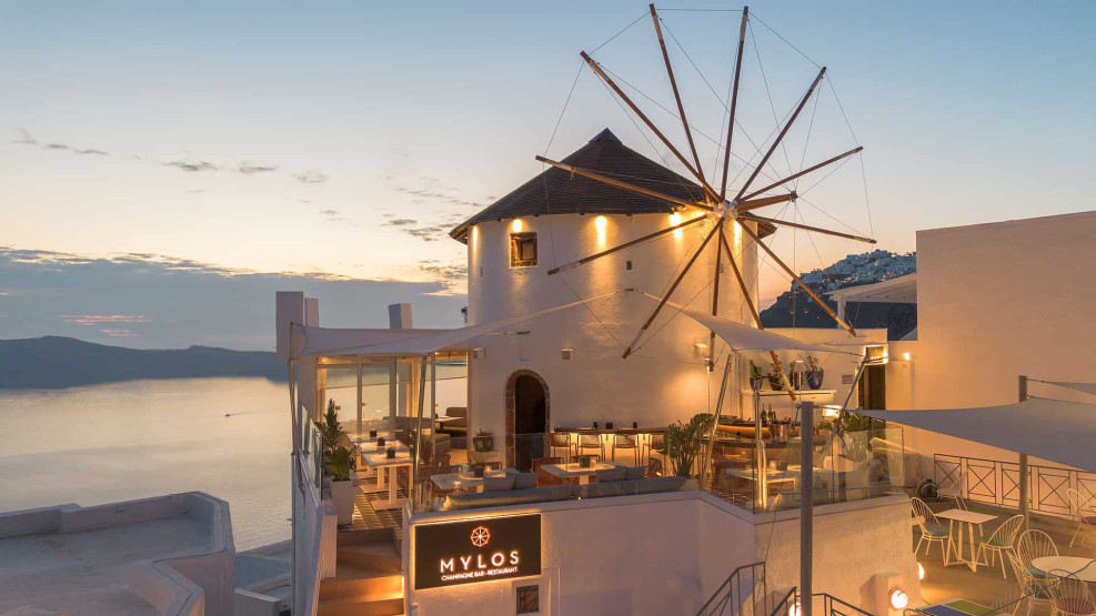 Romantic Sunset Restaurants in Santorini - How to Reserve the Best Romantic Sunset Restaurants in Santorini, Greece Terrace of the Mylos Champagne Bar Restaurant in Santorini, Greece.