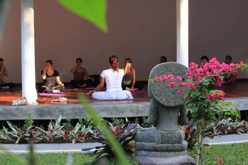 yoga retreats in Bali - Unforgettable Yoga Retreats in Bali Yoga session at the De Moksha Eco Friendly Boutique Resort in Tanah Lot in Bali, Indonesia.