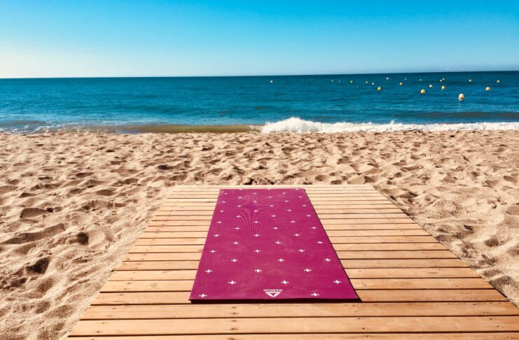 4 Unforgettable Yoga Retreats in Spain Yoga on the beach.