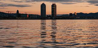 Things To Do at Sunrise in Barcelona Sunrise views of Barcelona from the sea.