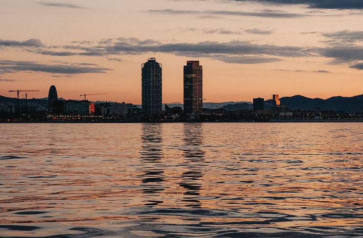 Things To Do at Sunrise in Barcelona Sunrise views of Barcelona from the sea.