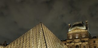 What Is the Best Way To Visit the Louvre? The pyramid at the Louvre museum in Paris at night.