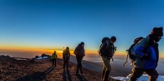 How to Trek to Point Lenana on Mount Kenya Climbing one of the summits of Mount Kenya at sunrise.