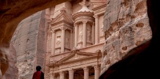Beyond Postcards: Why a Tattoo is the Ultimate Souvenir from Jordan Woman standing in front of the Treasury of Petra in Jordan, Photo by Ahmad Qaisieh - unsplash