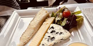 How to Eat Like a Local in Paris Slices of different French cheese.