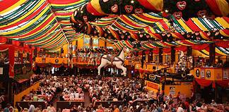 Culinary Guide to the Best Food at Oktoberfest in Munich Visitors at the Hippodrom beer tent at the Oktoberfest in Munich, Germany.