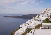 A Guide to Ecotourism in Santorini This image shows Imerovigli with Oia in the distance.