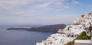 A Guide to Ecotourism in Santorini This image shows Imerovigli with Oia in the distance.