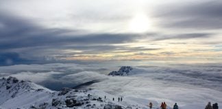 Best Time to Climb Mount Kilimanjaro Sunrise above the clouds at Kilimanjaro in Tanzania. Just below the summit Uhuru Peak.
