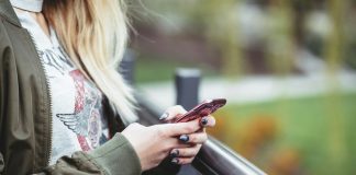 How to Save on International Data Roaming While Traveling: Smart Tips and Tools A woman on a smartphone texting using international data roaming