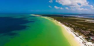 Cancun’s Island Get Away: Discover the Best Routes from Cancun to Holbox and Isla Mujeres Drone pic of the beach of Holbox in Quintana Roo, Mexico.