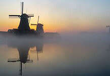 Navigating Internet Access in the Netherlands: A Traveler’s Guide Mills at sunrise in the Netherlands.