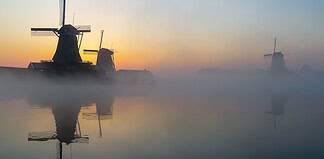 Navigating Internet Access in the Netherlands: A Traveler’s Guide Mills at sunrise in the Netherlands.
