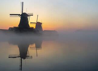 Navigating Internet Access in the Netherlands: A Traveler’s Guide Mills at sunrise in the Netherlands.