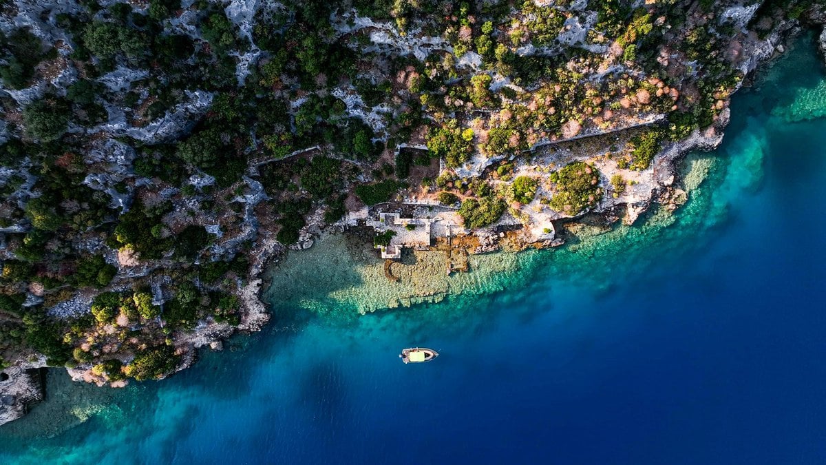 kekova blue cruise - Kekova Blue Cruise Guide: Cabin Charter vs Private Gulet Explained Aerial view of Sunken city in Kekova, Antalya.