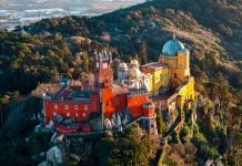 Which Sintra Tour Should You Book? Half-Day vs. Full-Day Pena Palace in Sintra Portugal surrounded by lush forest and romantic architecture