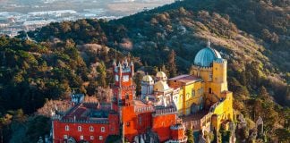 Which Sintra Tour Should You Book? Half-Day vs. Full-Day Pena Palace in Sintra Portugal surrounded by lush forest and romantic architecture