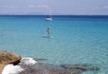 What to Do on a Day Trip or Short Stay in Formentera from Ibiza SUP and sailing yacht in Formentera, Spain.