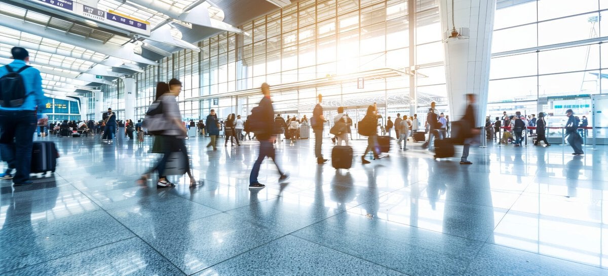 - Why Travelers Now Plan Around How They Want to Feel Airport building with travelers