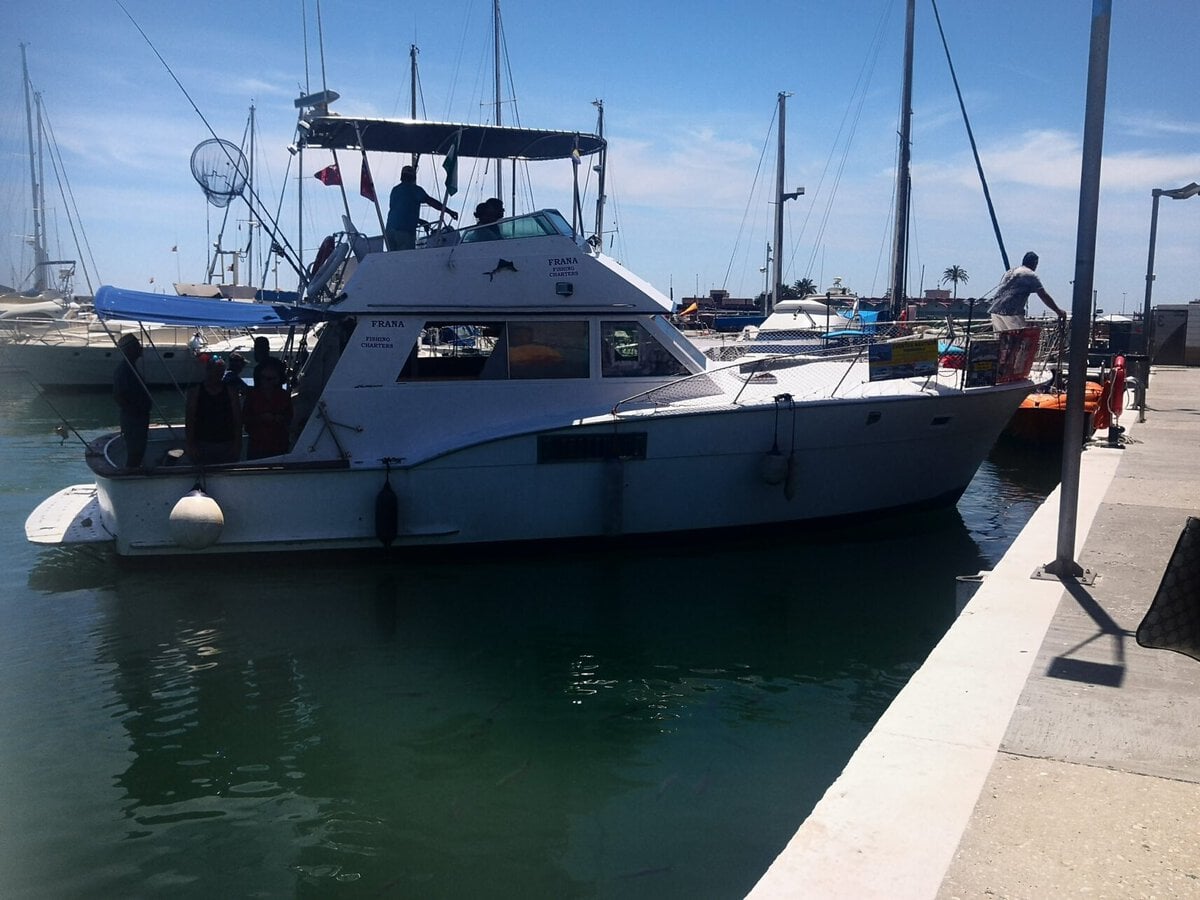 A local tourist boat offering coastal cruises and deep-sea fishing trips moored at the Fuengirola port marina for people visiting Fuengirola