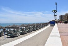 Where to Slow Down When Visiting Fuengirola Wide view of the sun-drenched Paseo Maritimo beach promenade and sandy coastline in Fuengirola, Costa del Sol.