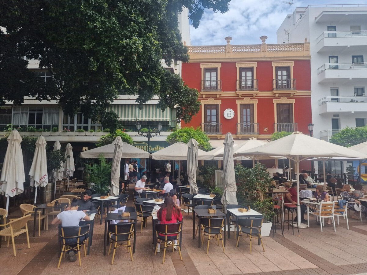 Outdoor café tables and tapas bars under the trees at the vibrant Plaza de la Constitucion square in Fuengirola