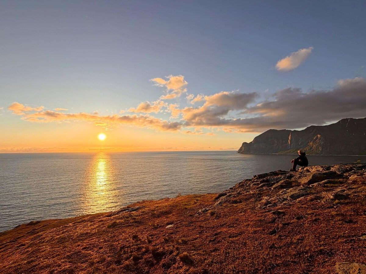 Jake, from Penguin Trampoline, watching the midnight sun in Northern Norway