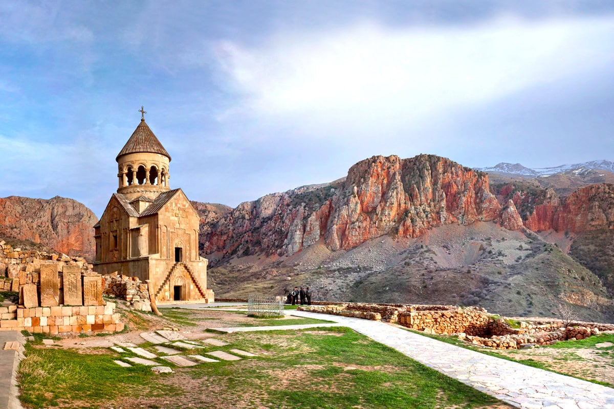 - Seven Days in Armenia, Where the Past Is Still in Everyday Use Noravank against red cliffs, Armenia.
