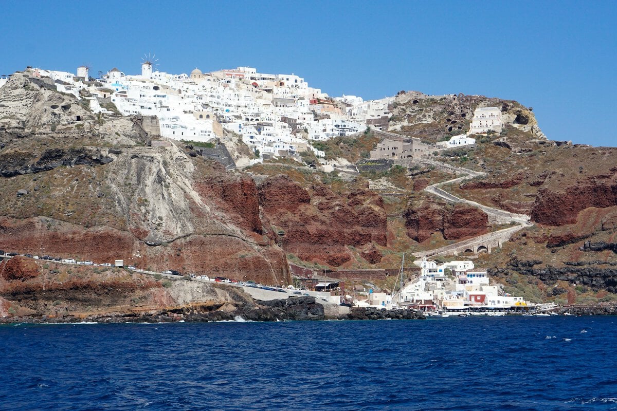 Santorini Cable Car - How to Skip the Santorini Cable Car: A Better Start to Your Cruise Day Picturesque Santorini village with white buildings on cliffs overlooking the sea.