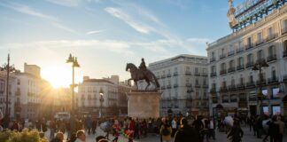 Eating Through Madrid’s Old Quarter in Three Days Sun peaking over buildings in Puerta del Sol, Madrid, Spain