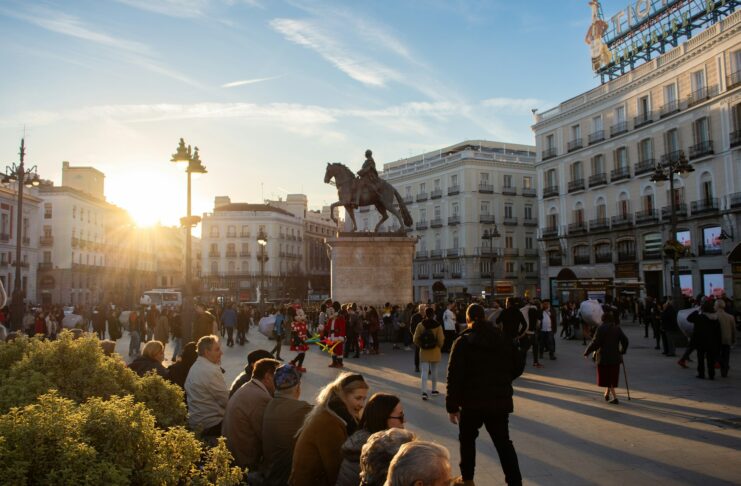 Eating Through Madrid’s Old Quarter in Three Days Sun peaking over buildings in Puerta del Sol, Madrid, Spain